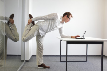 man doing an exercise at a desk