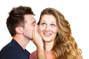 Young Man Whispering A Secret to women