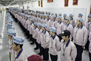 Workers line up for role call before entering their work stations at a Pegatron factory in Shanghai, China on Friday, 15 April 2016. Photographer: Qilai Shen / Bloomberg