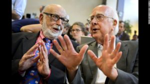 British physicist Peter Higgs (R) speaks with Belgium physicist Francois Englert at a press conference on July 4, 2012 at European Organization for Nuclear Research (CERN) offices in Meyrin near Geneva. After a quest spanning nearly half a century, physicists said on July 4 they had found a new sub-atomic particle consistent with the Higgs boson which is believed to confer mass. Rousing cheers and a standing ovation broke out at the CERN after scientists presented data in their long search for the mysterious particle. AFP PHOTO / FABRICE COFFRINI (Photo credit should read FABRICE COFFRINI/AFP/GettyImages)